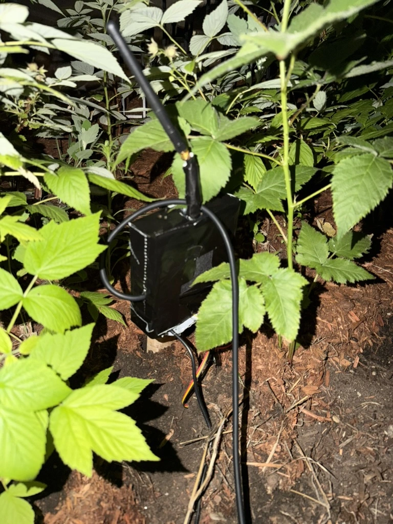 AgriScan Hub device - a compact white weatherproof sensor with soil probe